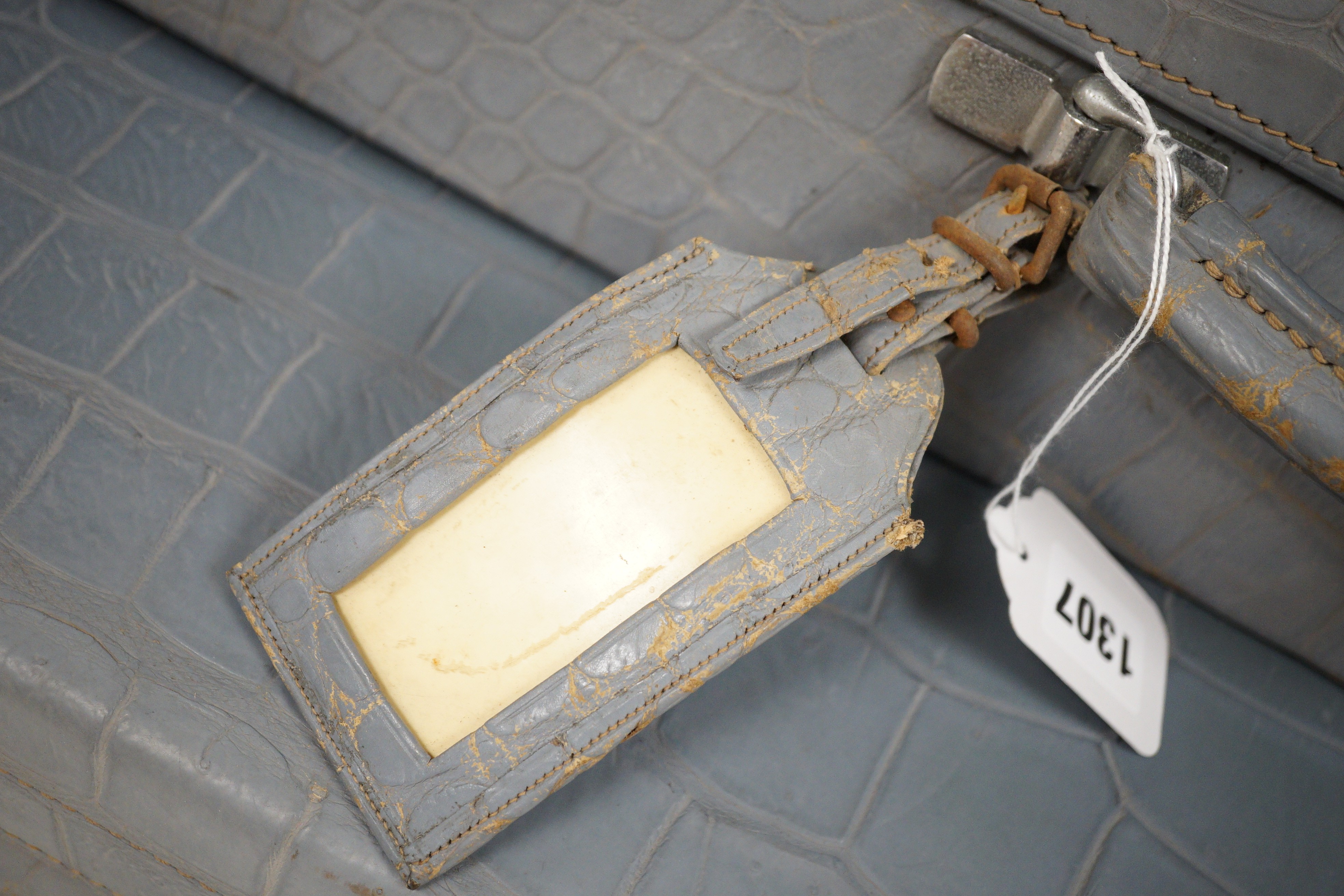 A pair of blue/grey faux crocodile suitcases